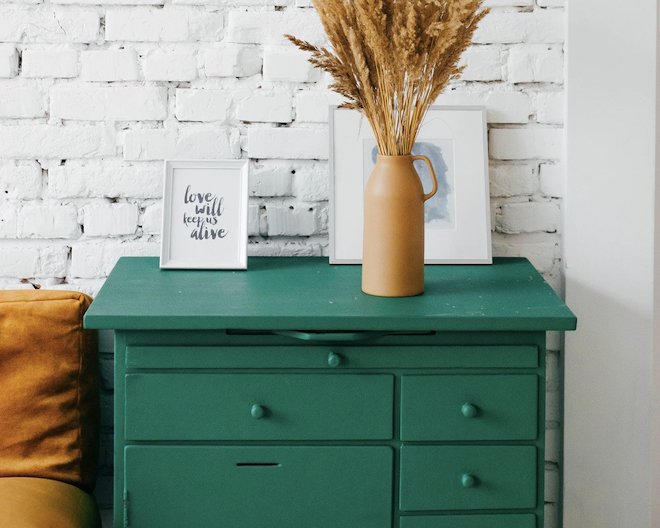 green drawer table with decor on top